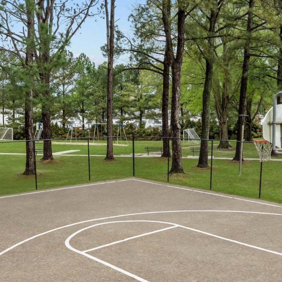 a tennis court with trees