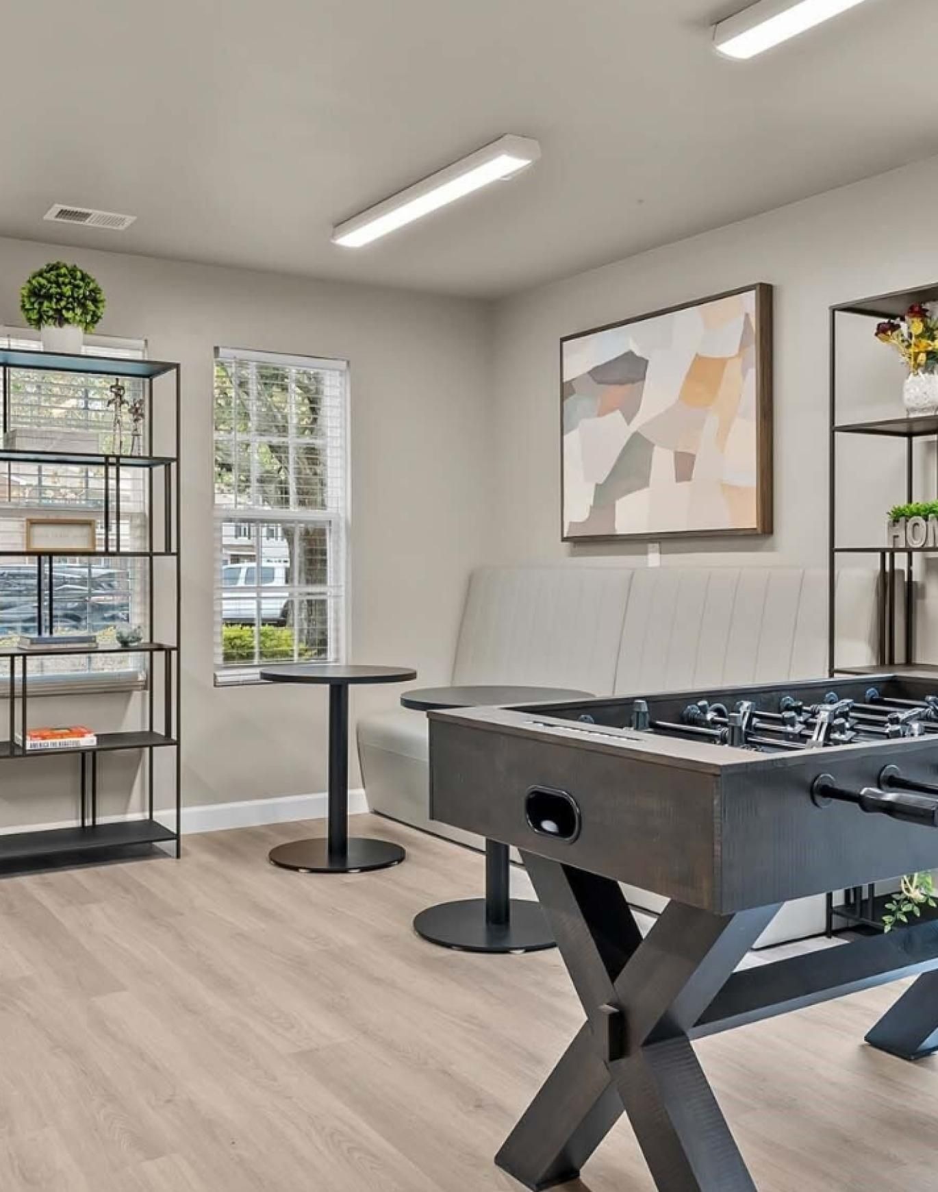 a room with a pool table and a large window